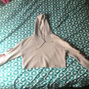 A gray cropped side rose hoodie